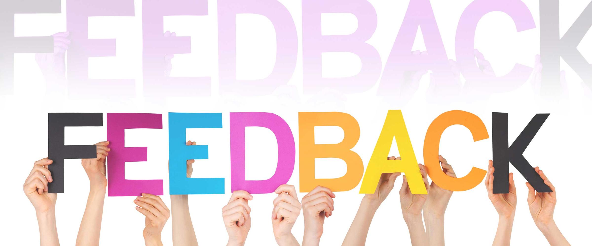 Photo of hands holding letters spelling Feedback