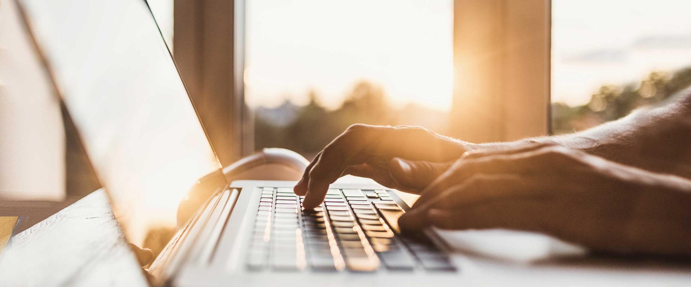 Photo of someone typing on a laptop computer